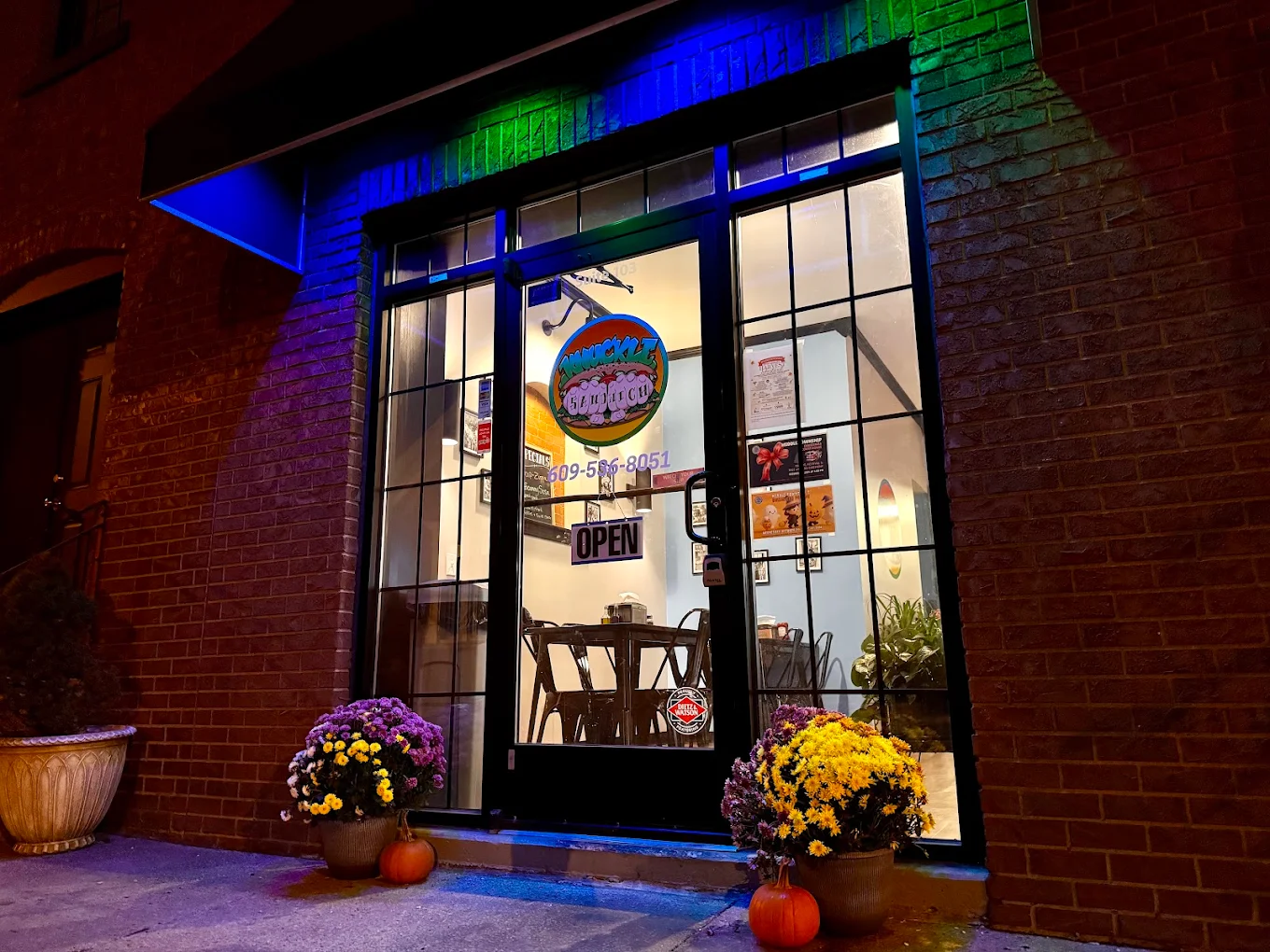 Knuckle Sandwich Deli storefront at night